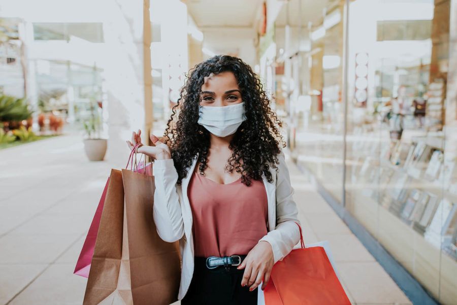 Woman walking shopping and Smiling behind the mask COVID