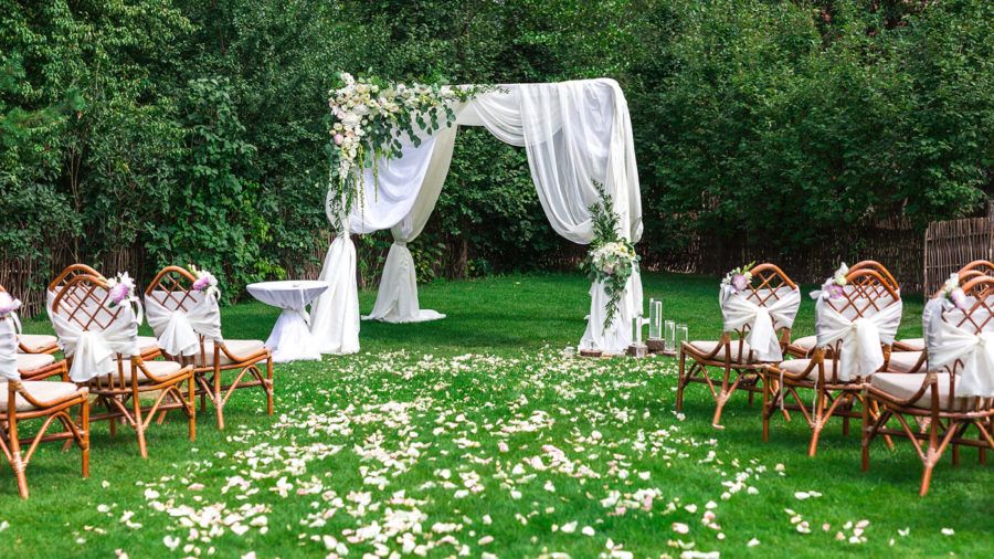 Beautiful setting for outdoors wedding ceremony waiting for bride and groom and guests. Decoration