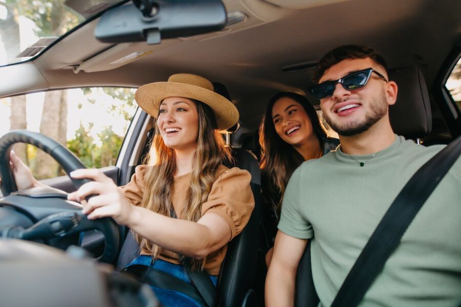 happy friends traveling by car.