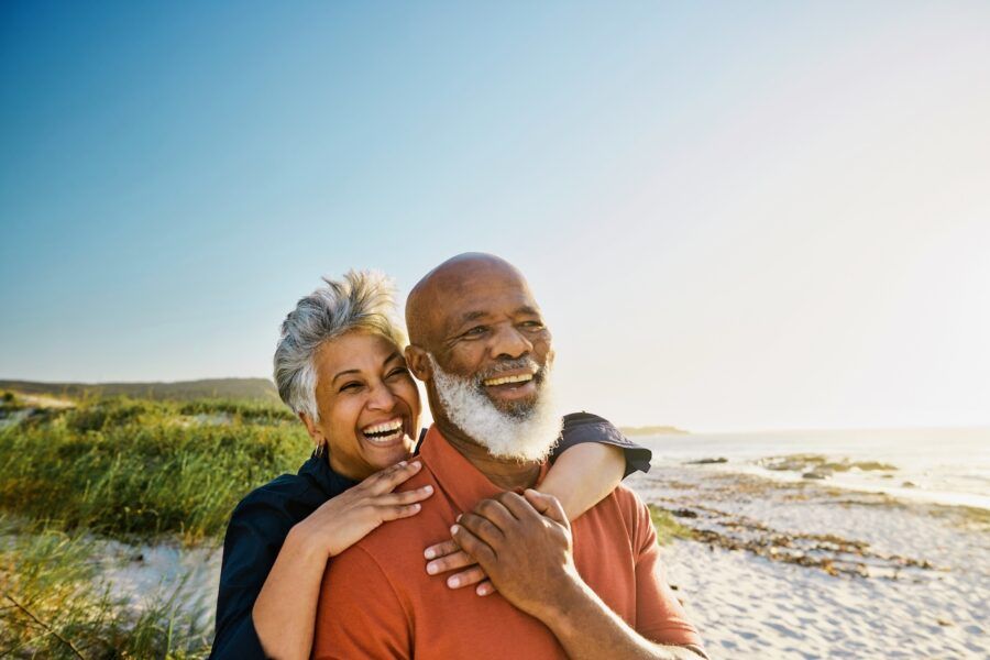 Happy senior couple enjoying their vacation on the beach