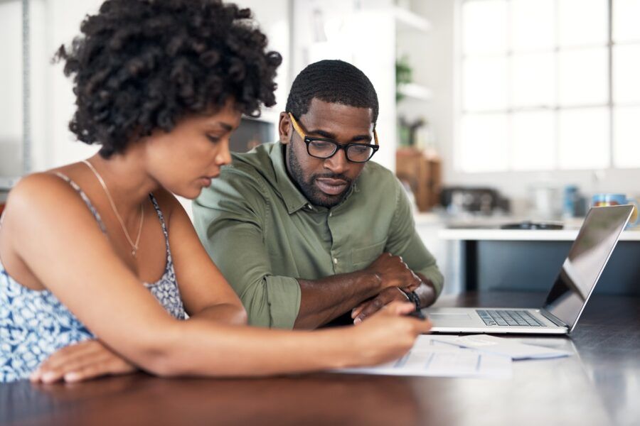 Shot of a young couple going through paperwork at home