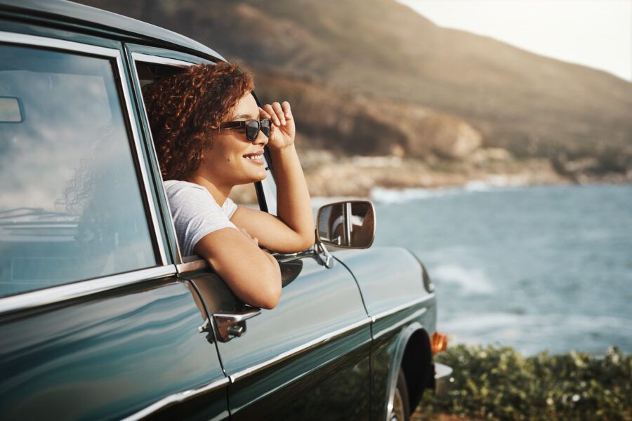 Shot of a young woman enjoying a road trip