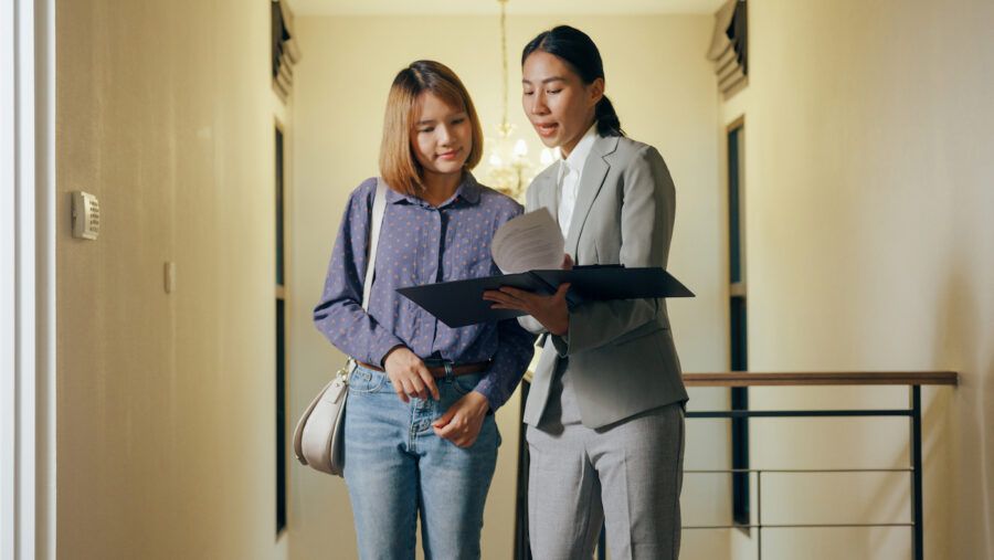 Real estate agent reviews lease with tenant