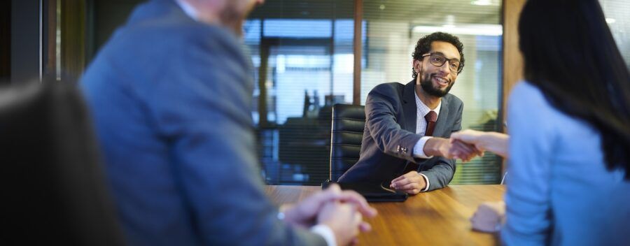 A man meeting with attorneys.