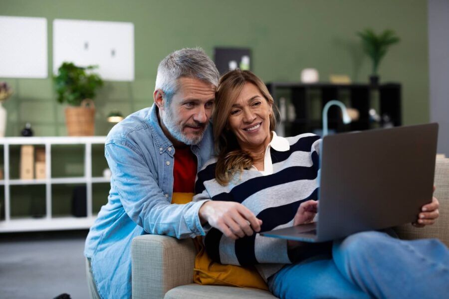 Mature couple using a laptop together in the living room