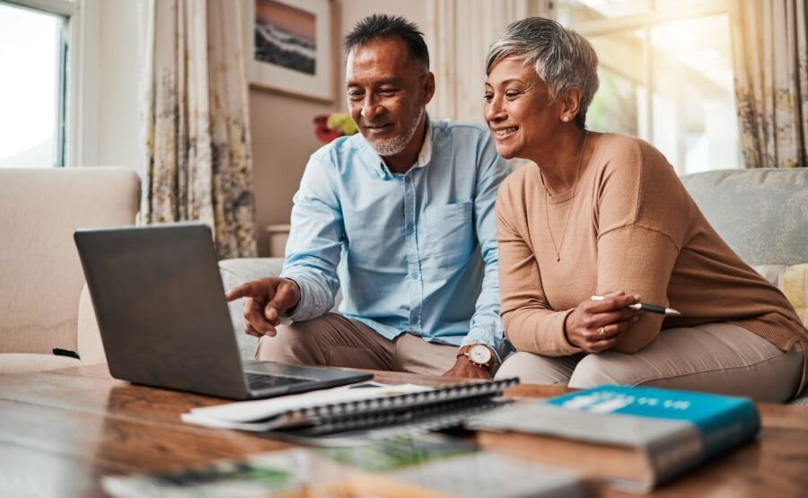 Mature couple checking something on the laptop in their living room