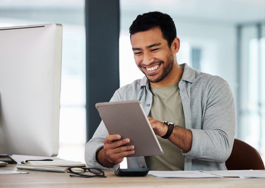Shot of a young businessman using his digital tablet to review his employee stock purchase plan.