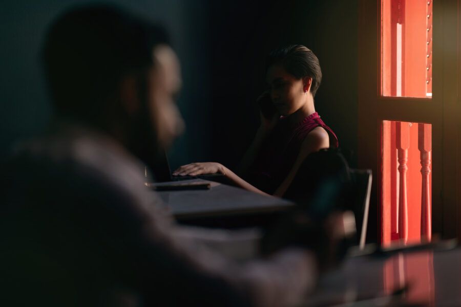 Mysterious and dark mood image of an female using phone.