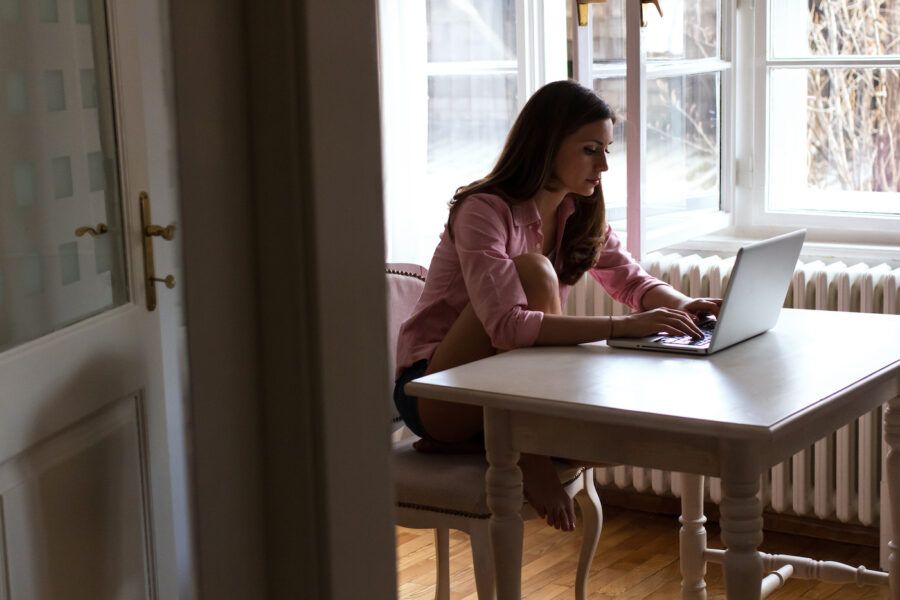 Young woman using her laptop in the living room.