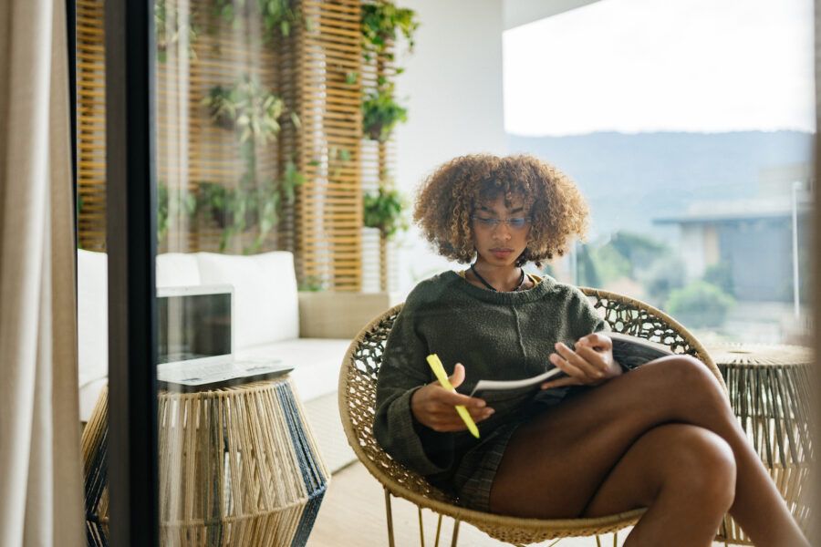 Woman taking notes on her porch